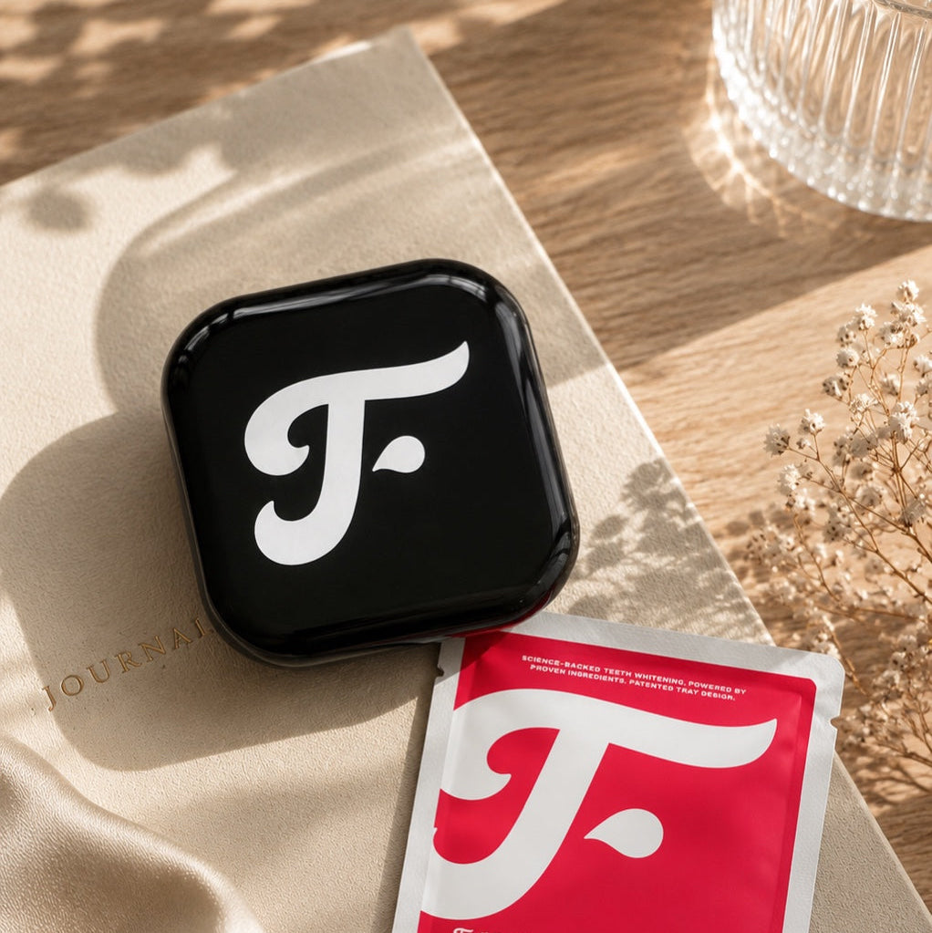 Black Toothfloof Tray Case on a beige surface.