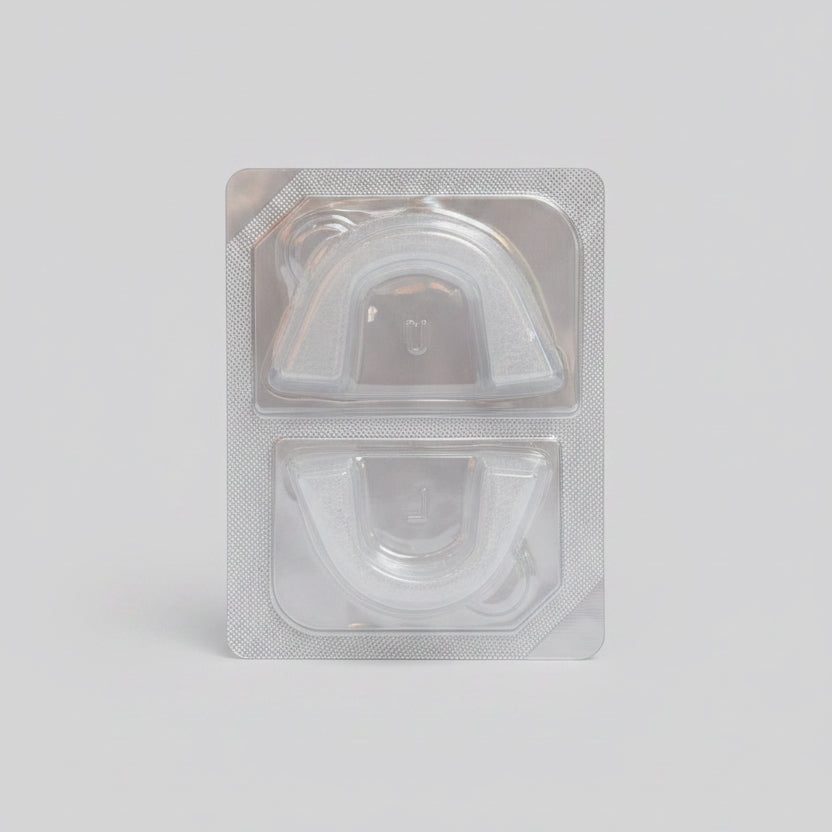 Bottom of Toothfloof Orawrap Clear plastic packaging with a white background