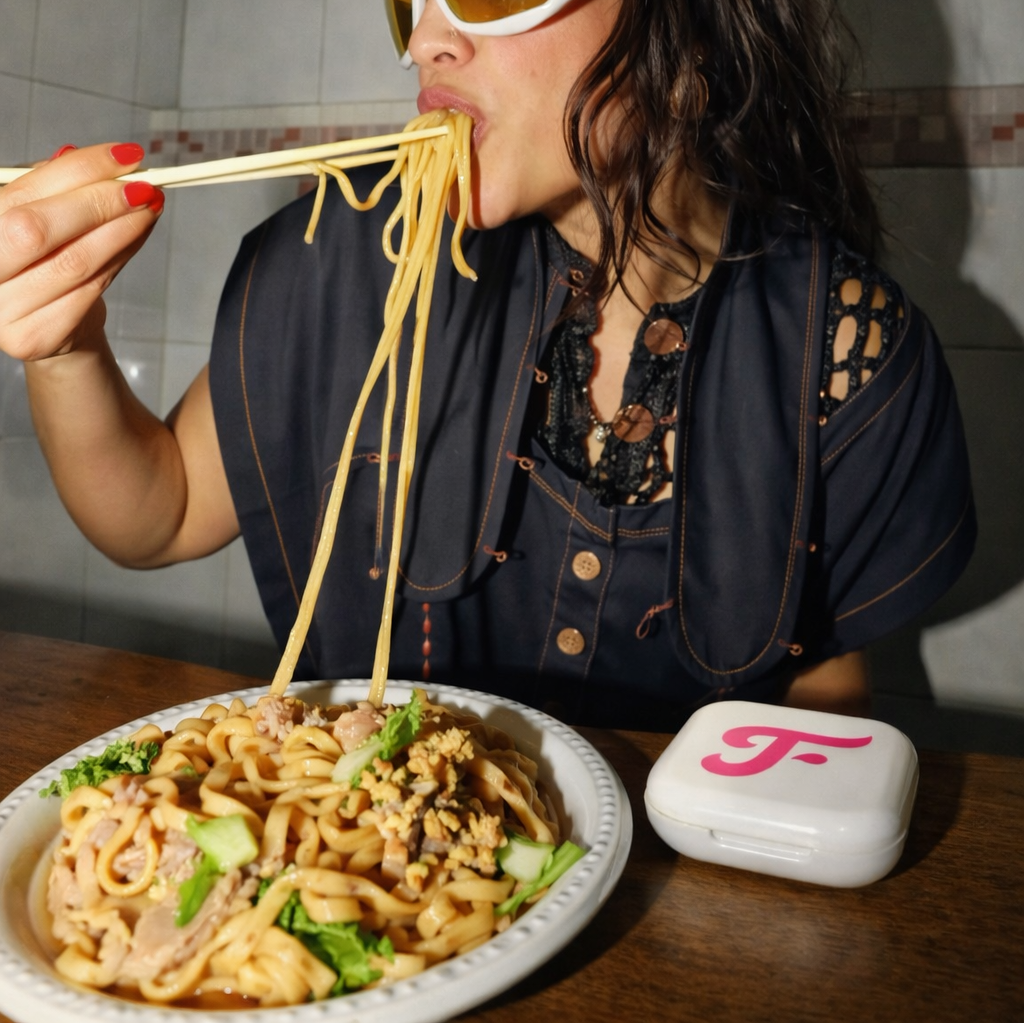 Person eating noodles with a plate of food and sunglasses with Toothfloof White Dental Orawrap Tray Storage Case on table